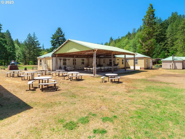 exterior space with an outdoor living space with a fire pit, a patio area, and a yard