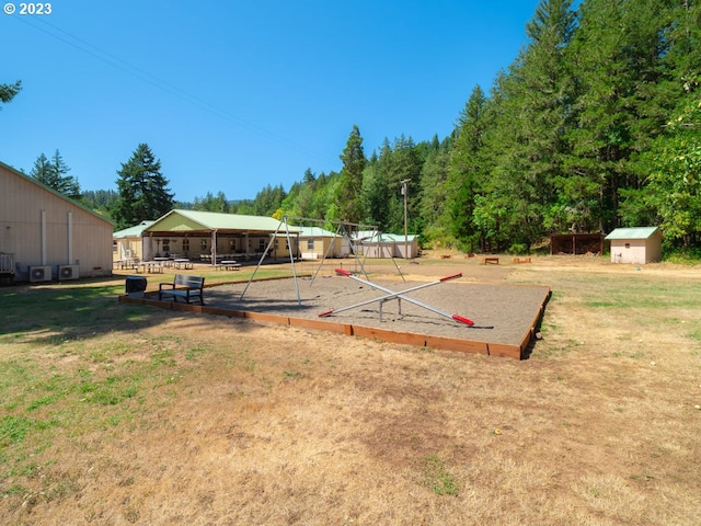 exterior space featuring a playground and a shed