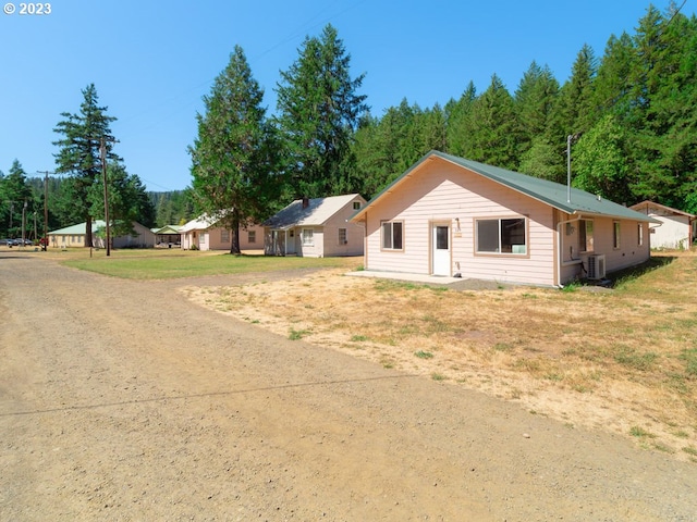 rear view of property featuring central AC unit