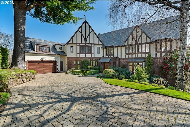 tudor-style house featuring a garage