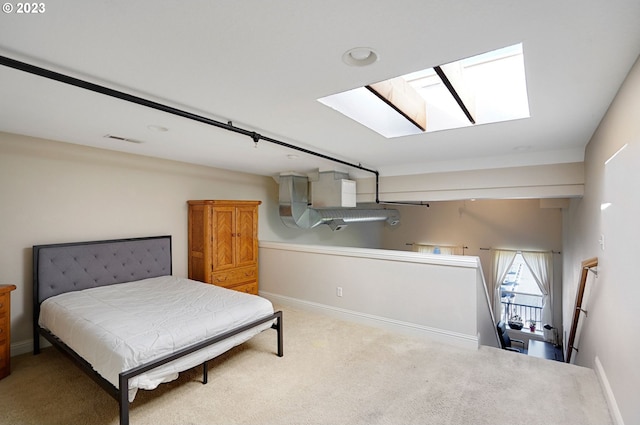 carpeted bedroom with a skylight