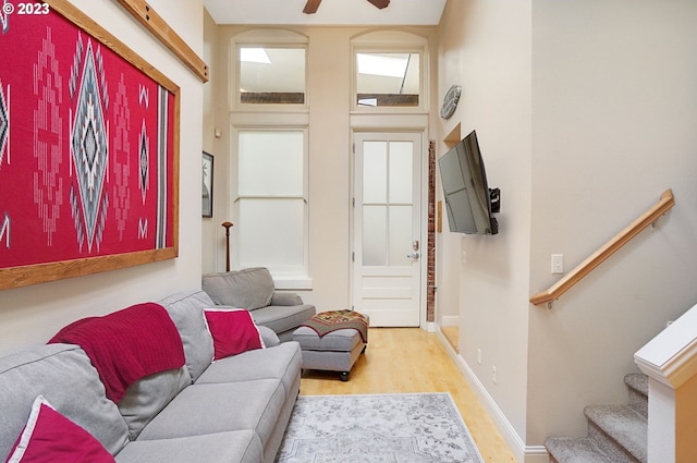 living room featuring ceiling fan and light hardwood / wood-style flooring