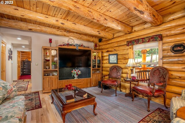 living room with beam ceiling, log walls, light hardwood / wood-style floors, and wooden ceiling