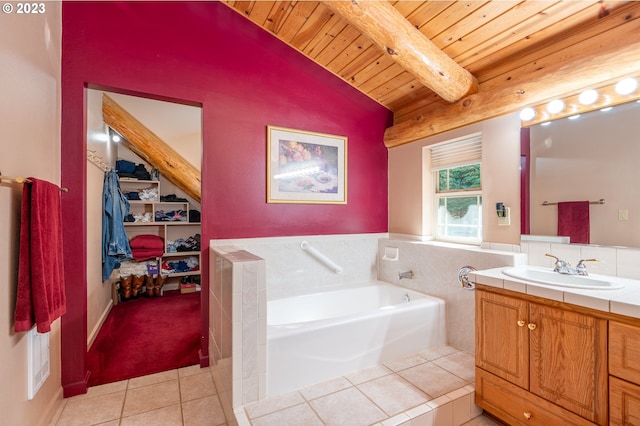 bathroom with vaulted ceiling with beams, tile flooring, large vanity, and a tub