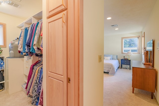 spacious closet featuring light carpet