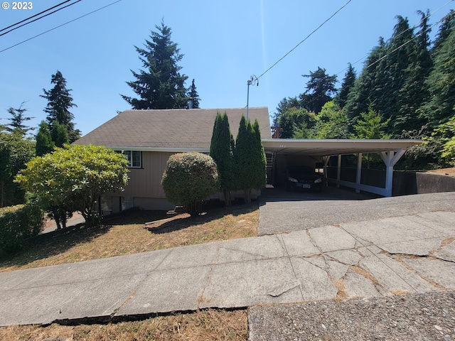 view of side of home with a carport