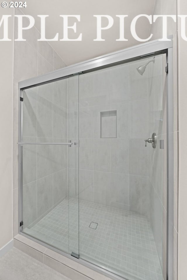 bathroom with a shower with shower door