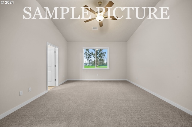 carpeted empty room with ceiling fan and lofted ceiling