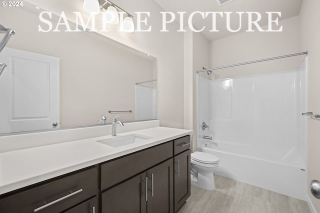 full bathroom with hardwood / wood-style floors, vanity, toilet, and shower / tub combination