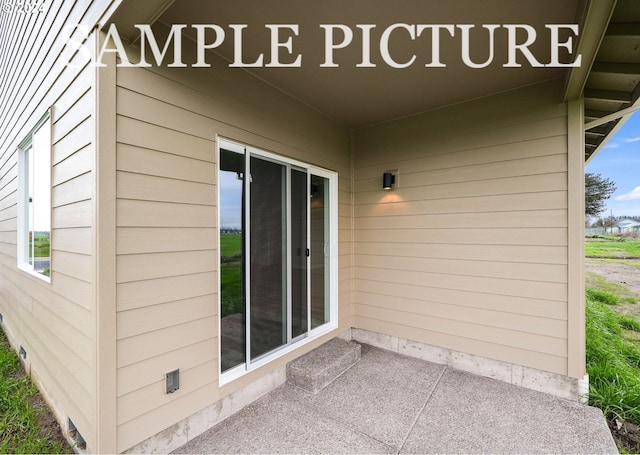 view of exterior entry featuring a patio area