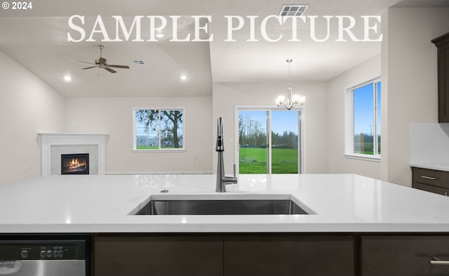 kitchen with dishwasher, decorative light fixtures, sink, and ceiling fan with notable chandelier