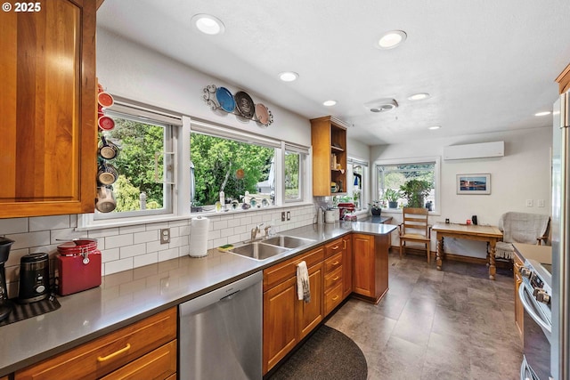 kitchen with an AC wall unit, brown cabinetry, appliances with stainless steel finishes, and recessed lighting
