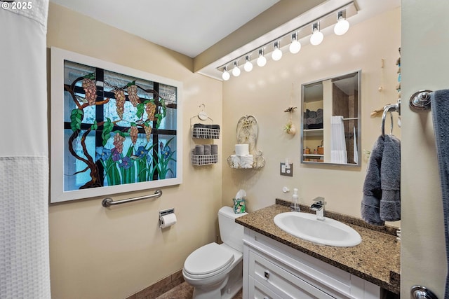 full bath featuring vanity and toilet
