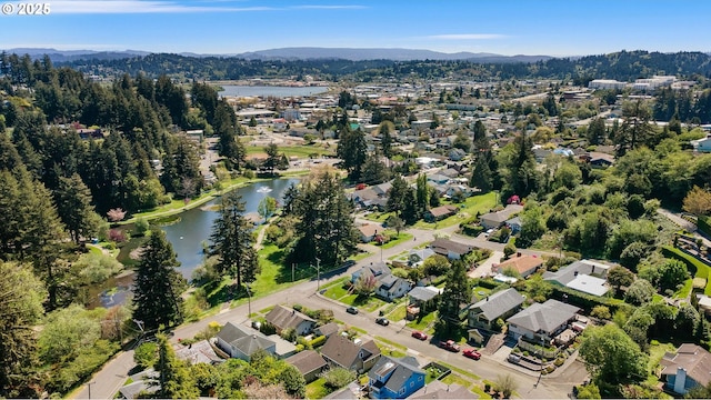 drone / aerial view featuring a residential view and a water and mountain view