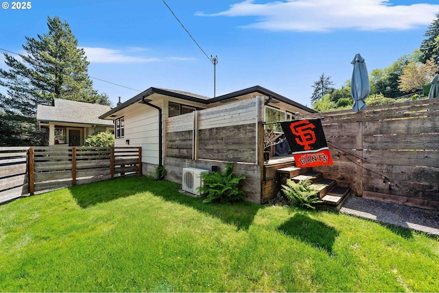 exterior space featuring a fenced backyard and ac unit
