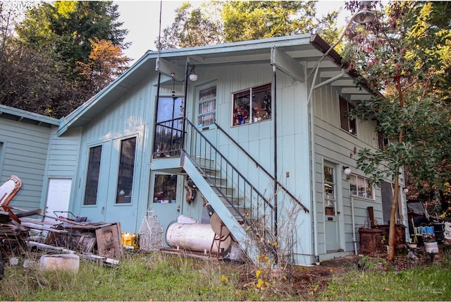 rear view of property with stairway