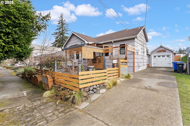 view of front of home with a garage and an outdoor structure