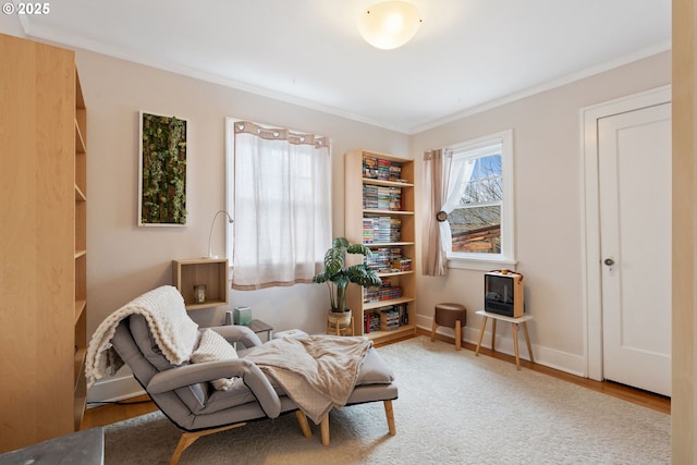 sitting room featuring hardwood / wood-style flooring and crown molding