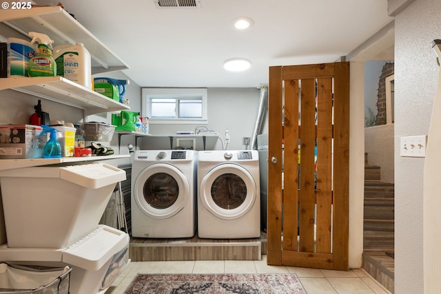 laundry room with light tile patterned floors and independent washer and dryer