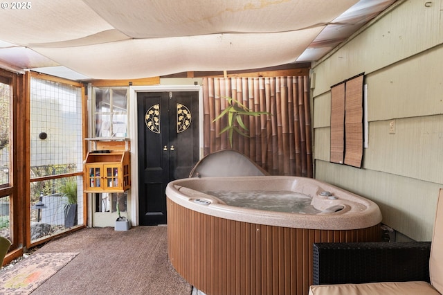 miscellaneous room with a hot tub, vaulted ceiling, and carpet floors