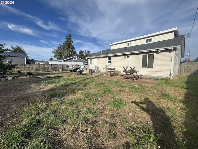 rear view of house with a yard