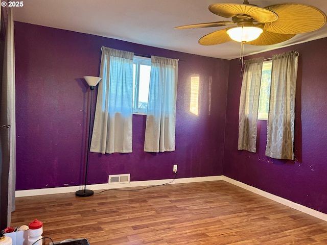 empty room featuring ceiling fan and wood-type flooring