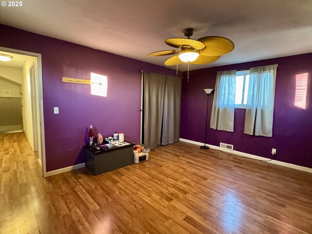 unfurnished bedroom with wood-type flooring and ceiling fan