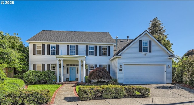 17472 NW Gilbert Ln, Portland, OR 97229 - colonial house with concrete driveway, a garage, and a shingled roof