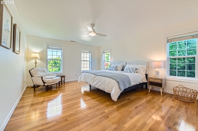 17472 NW Gilbert Ln, Portland, OR 97229 - bedroom featuring light wood-style floors, baseboards, and a ceiling fan