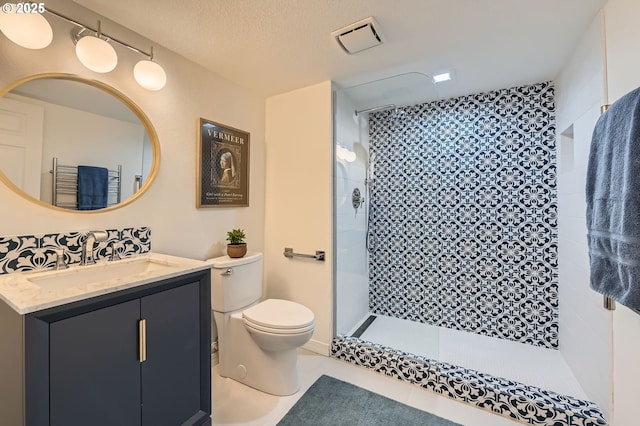 17472 NW Gilbert Ln, Portland, OR 97229 - bathroom with toilet, a tile shower, vanity, and tile patterned floors
