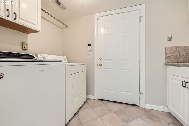 17472 NW Gilbert Ln, Portland, OR 97229 - laundry room with washing machine and dryer, cabinet space, baseboards, and light tile patterned floors
