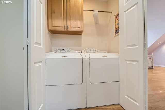 17472 NW Gilbert Ln, Portland, OR 97229 - washroom with cabinet space, washing machine and dryer, and light wood-style floors