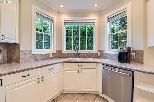 17472 NW Gilbert Ln, Portland, OR 97229 - kitchen with stainless steel dishwasher, a sink, crown molding, white cabinets, and light tile patterned floors