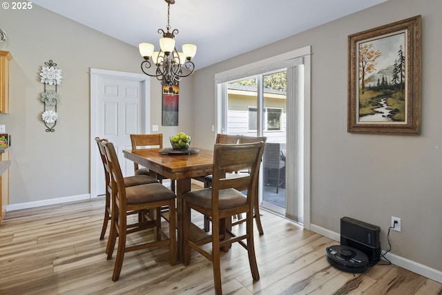 2057 SE Blue Skies Ln, Prineville, OR 97754 - dining area with a chandelier, light wood-style floors, and baseboards
