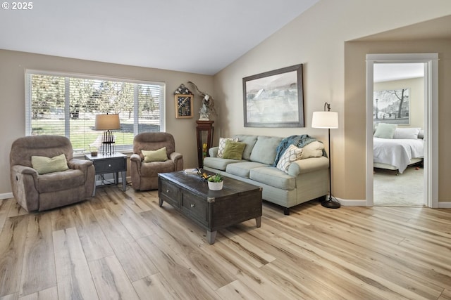 2057 SE Blue Skies Ln, Prineville, OR 97754 - living area with light wood-style floors, vaulted ceiling, and baseboards