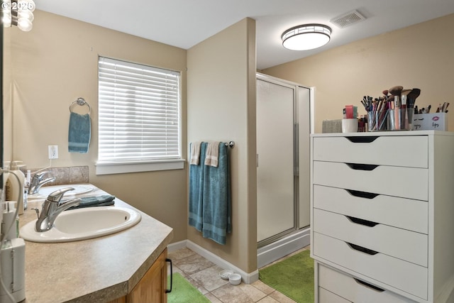 2057 SE Blue Skies Ln, Prineville, OR 97754 - full bathroom with a stall shower, double vanity, tile patterned flooring, and baseboards