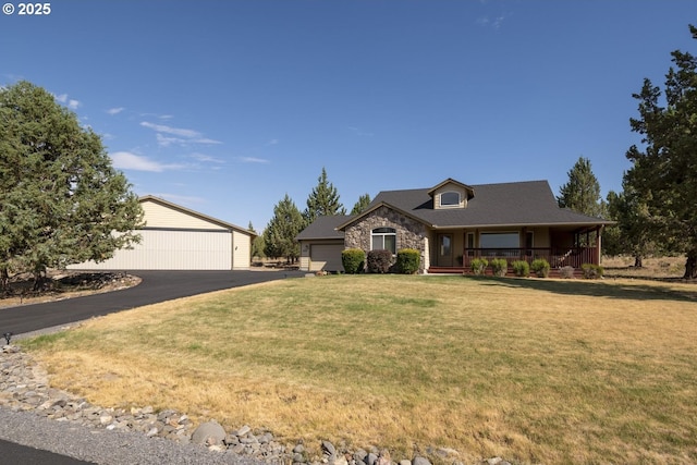2057 SE Blue Skies Ln, Prineville, OR 97754 - view of front of property with covered porch, a front lawn, stone siding, and an outdoor structure