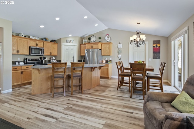 2057 SE Blue Skies Ln, Prineville, OR 97754 - kitchen with appliances with stainless steel finishes, light wood finished floors, open floor plan, lofted ceiling, and a chandelier