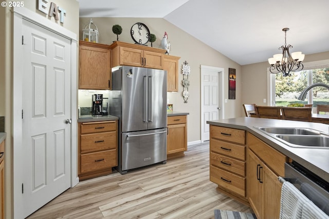 2057 SE Blue Skies Ln, Prineville, OR 97754 - kitchen featuring freestanding refrigerator, dishwasher, lofted ceiling, a sink, and light wood-style flooring
