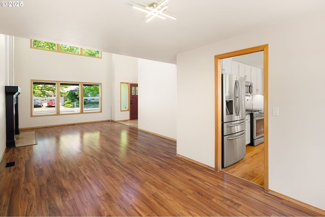 unfurnished living room featuring light wood-style floors and baseboards