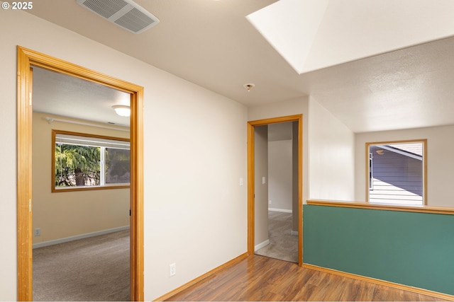 unfurnished bedroom with baseboards and wood finished floors