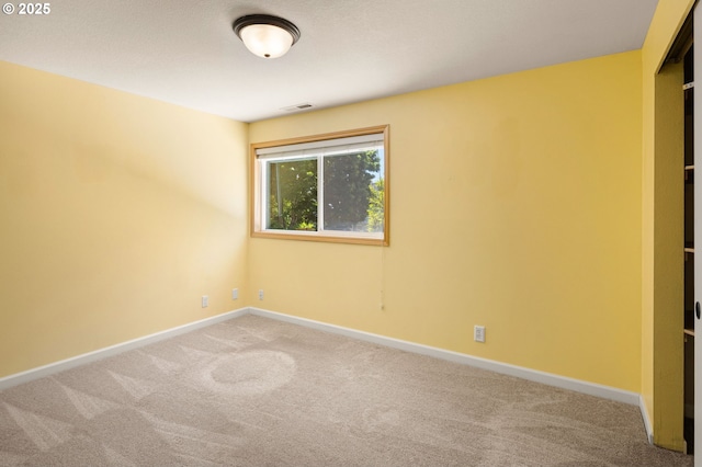 carpeted empty room with baseboards