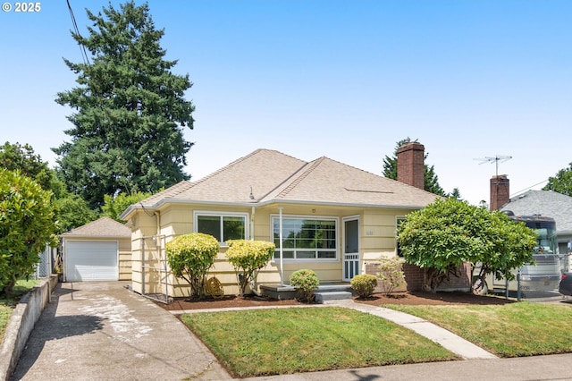6105 NE 18th Ave, Portland, OR 97211 - view of front of property with driveway, an outdoor structure, roof with shingles, a front lawn, and a detached garage