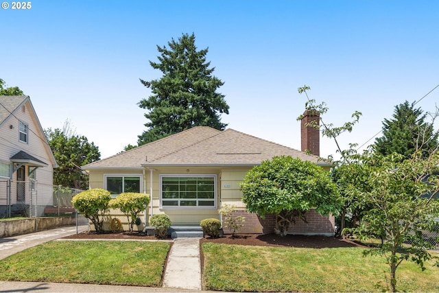 6105 NE 18th Ave, Portland, OR 97211 - view of front facade featuring a chimney, a front lawn, and roof with shingles