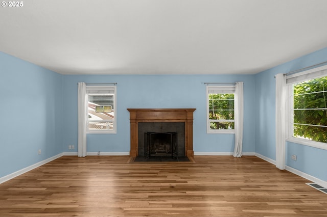6105 NE 18th Ave, Portland, OR 97211 - unfurnished living room featuring wood finished floors and a fireplace with flush hearth