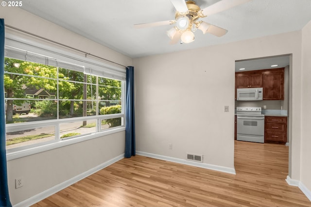 6105 NE 18th Ave, Portland, OR 97211 - empty room with light wood-style floors and a ceiling fan