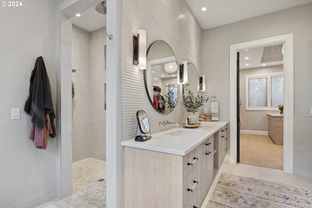 bathroom featuring tile patterned flooring, a shower, and vanity