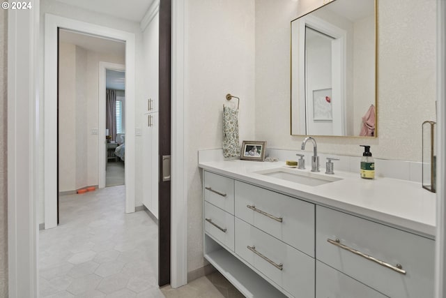 bathroom with tile patterned floors and vanity