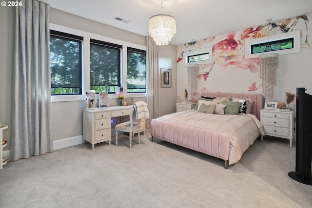 carpeted bedroom with a notable chandelier