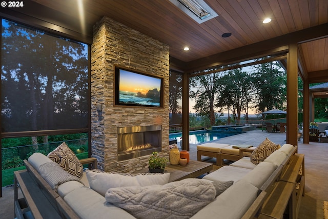 view of patio / terrace with an outdoor living space with a fireplace